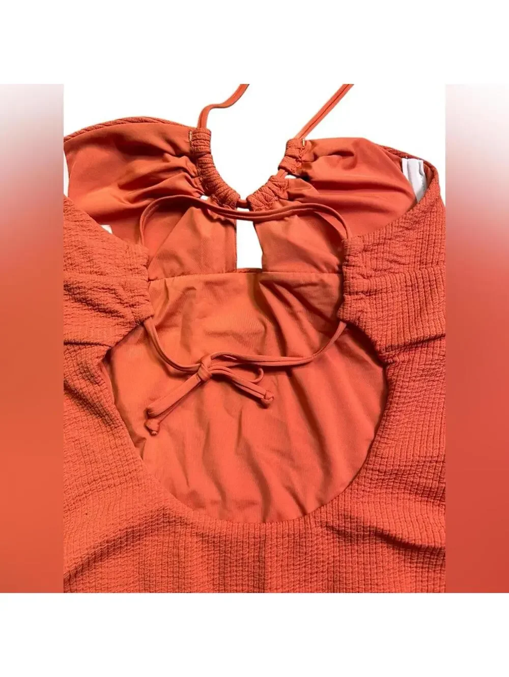 BECCA cut out textured tie back One Piece swimsuit rust orange size M $138 New